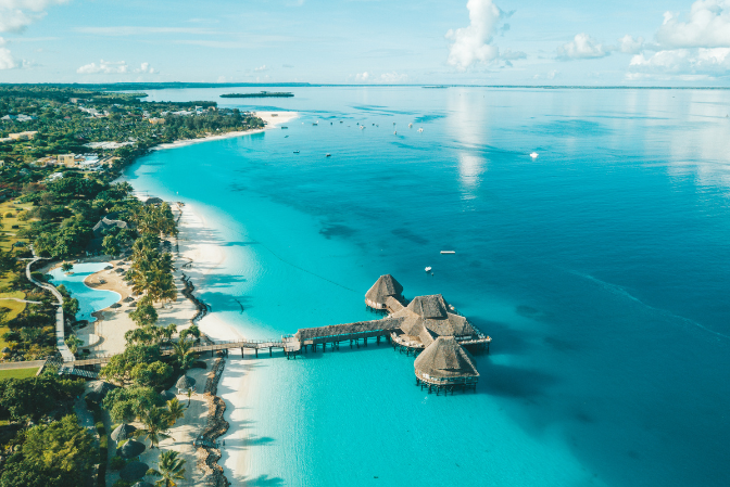 Aerial view of a luxury beach resort on the white-sand coast of Zanzibar, Tanzania